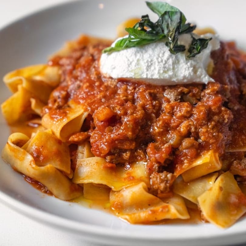 Favio's Trattoria's pappardelle pasta with rich bolognese sauce, ricotta, and fresh basil.